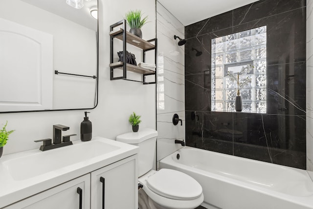 bathroom with vanity, toilet, and  shower combination