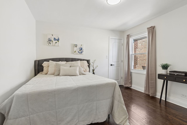 bedroom featuring dark wood-type flooring and baseboards