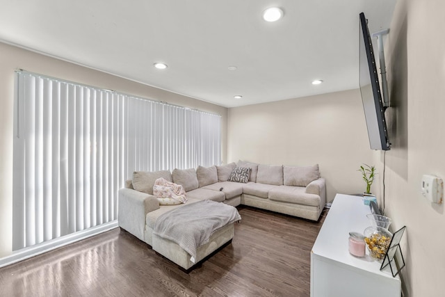 living room with recessed lighting and dark wood-style flooring