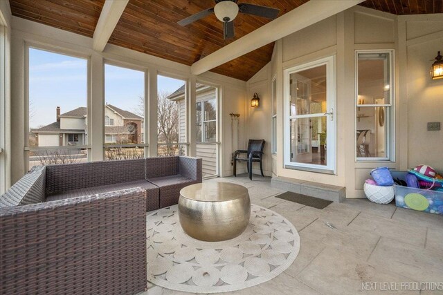 sunroom / solarium featuring wood ceiling, lofted ceiling with beams, and a ceiling fan