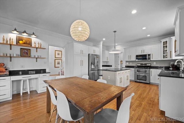 dining room featuring recessed lighting, light wood-style floors, and ornamental molding