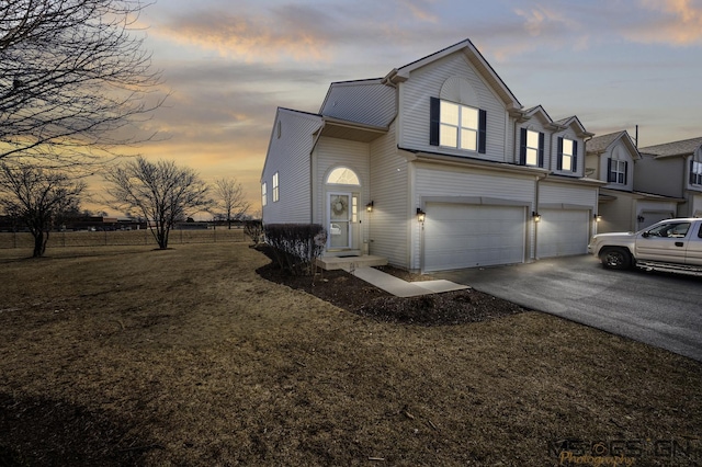 traditional home with aphalt driveway and a garage