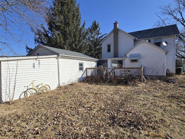 rear view of house featuring a deck