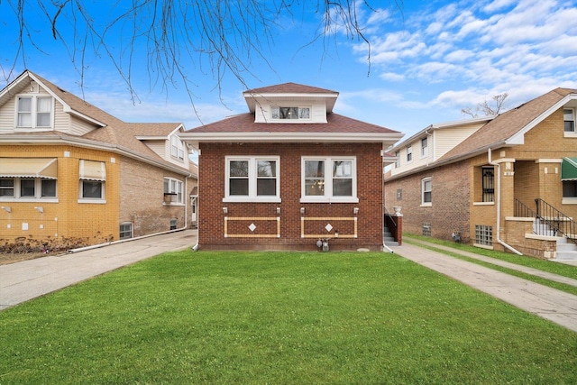 view of front facade with brick siding, roof with shingles, and a front yard