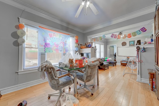 dining room featuring ceiling fan, light wood-style floors, baseboards, and ornamental molding