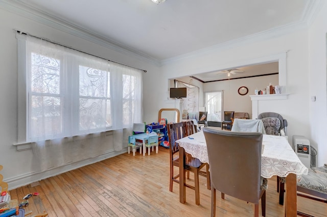 dining space featuring crown molding, light wood-style floors, and ceiling fan