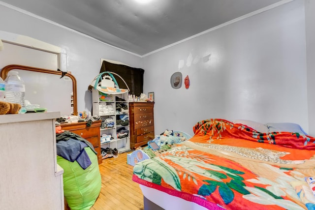 bedroom featuring light wood-style flooring and ornamental molding