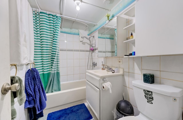 bathroom with toilet, tile walls, vanity, and shower / bath combination with curtain