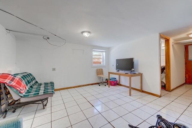 living area featuring light tile patterned floors and baseboards