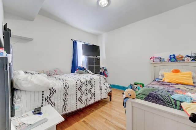 bedroom with baseboards and wood finished floors