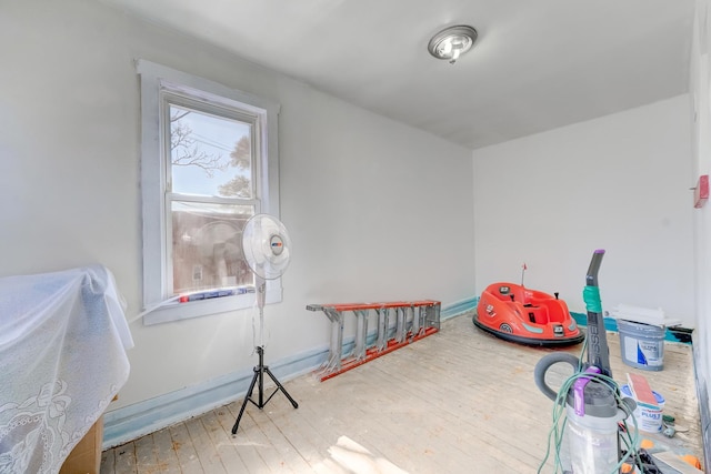 game room featuring baseboards and hardwood / wood-style floors