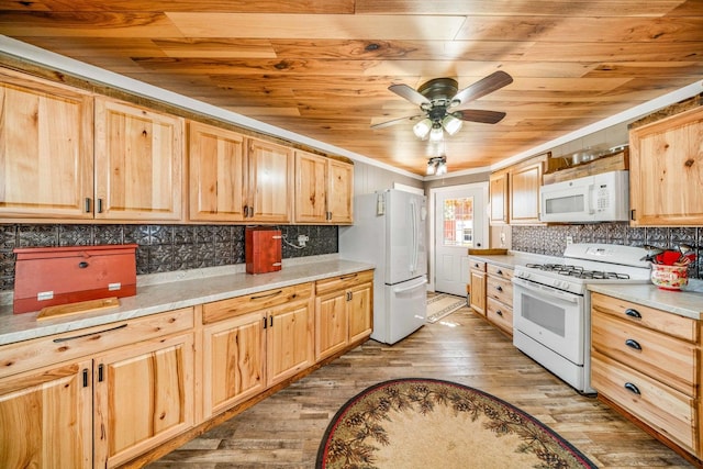 kitchen with decorative backsplash, white appliances, light brown cabinets, and light wood-type flooring