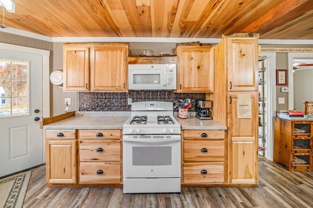 kitchen featuring decorative backsplash, white appliances, wood finished floors, and light countertops