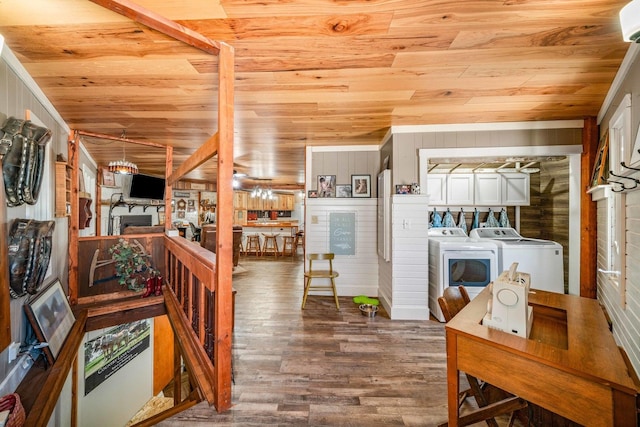 interior space with washer and dryer, wooden ceiling, wood walls, and wood finished floors