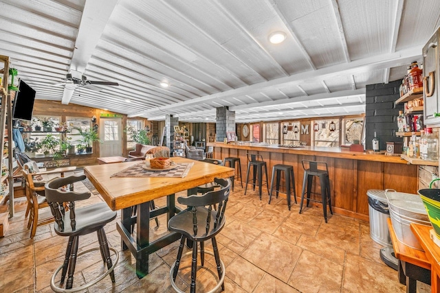 dining space with a ceiling fan and vaulted ceiling