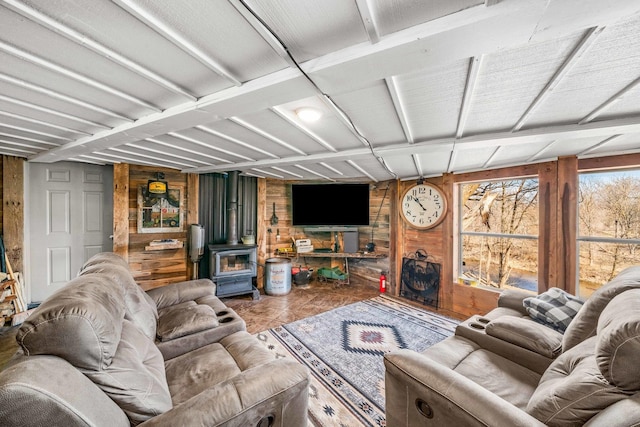 living room with wooden walls and a wood stove