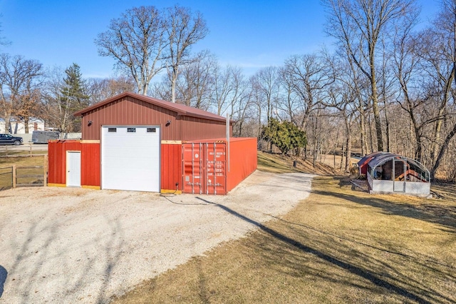 detached garage featuring fence