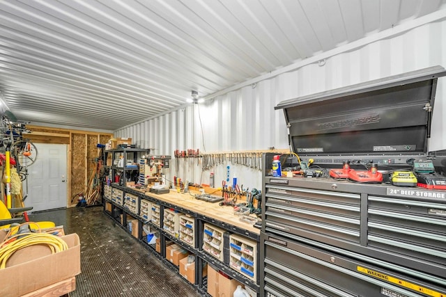 garage with a workshop area and metal wall