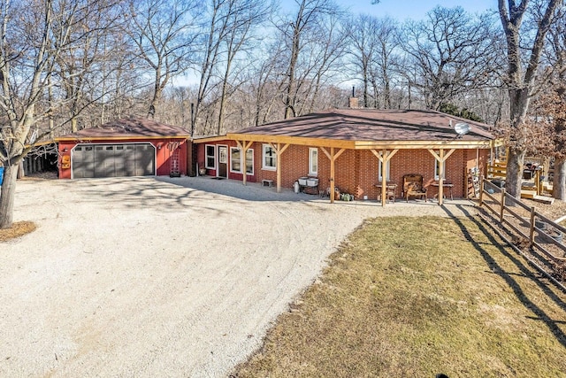 view of front facade featuring an attached garage, brick siding, and driveway