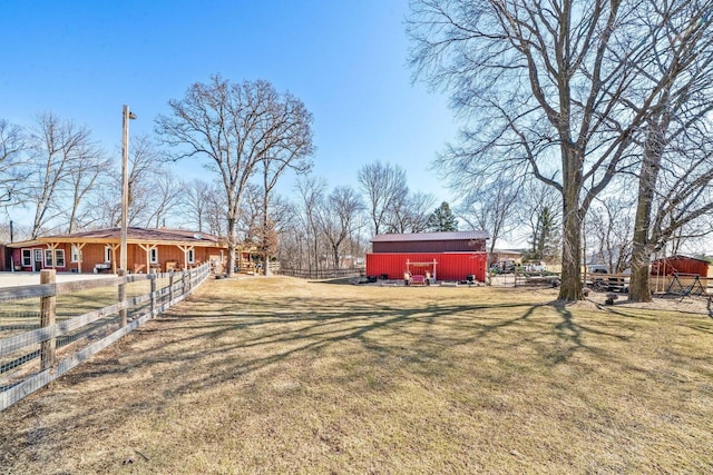 view of yard featuring an outbuilding and fence