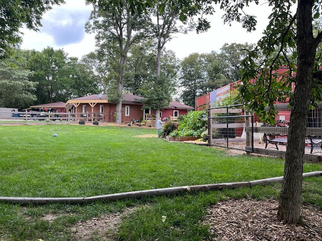 view of yard with a vegetable garden and fence