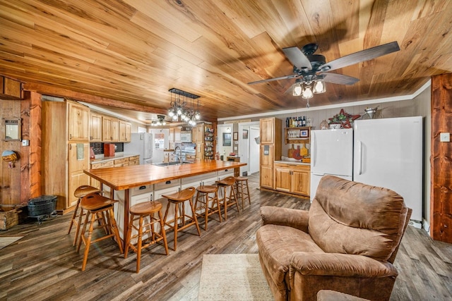 dining room featuring wood ceiling, dark wood-style floors, crown molding, and ceiling fan with notable chandelier