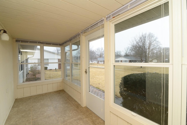 unfurnished sunroom with wooden ceiling