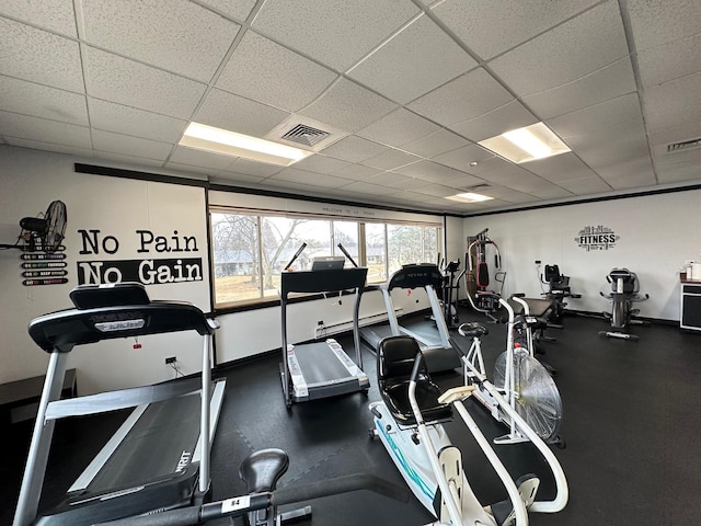 exercise room featuring visible vents, baseboards, and a drop ceiling