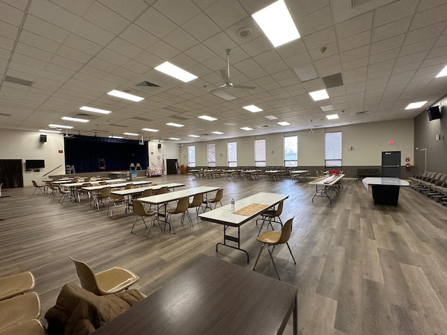 interior space with visible vents, a drop ceiling, and wood finished floors