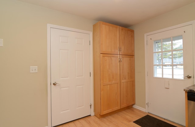 entryway with baseboards and light wood-style floors