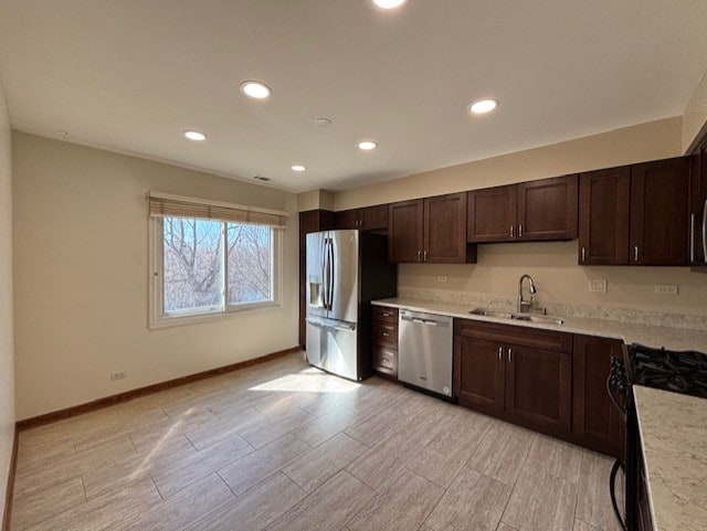 kitchen featuring a sink, light countertops, dark brown cabinets, and stainless steel appliances