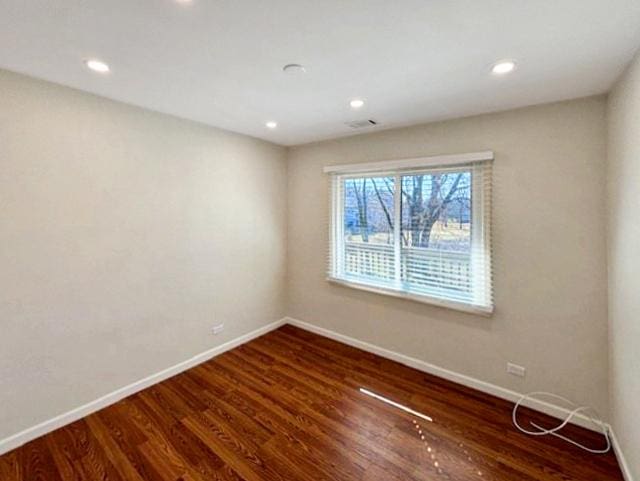 unfurnished room with visible vents, recessed lighting, wood finished floors, and baseboards