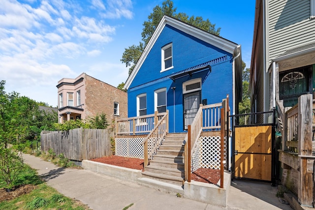 view of front facade featuring fence and brick siding