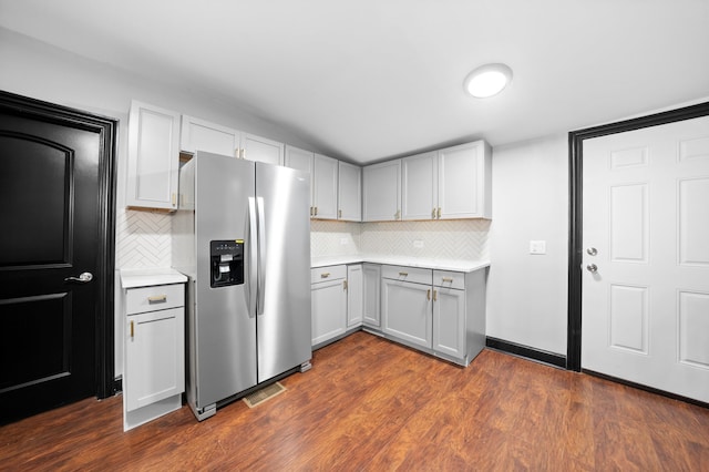 kitchen featuring dark wood-style floors, stainless steel fridge, and light countertops