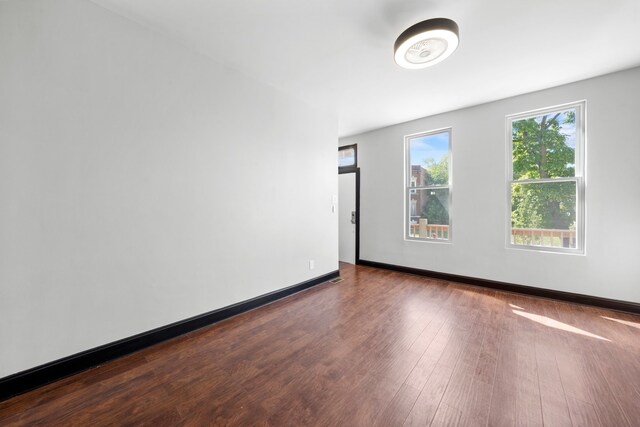 unfurnished room featuring dark wood finished floors and baseboards