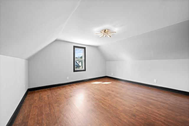 bonus room featuring vaulted ceiling, wood finished floors, and baseboards