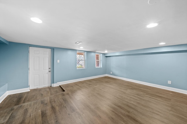 basement with visible vents, recessed lighting, baseboards, and wood finished floors