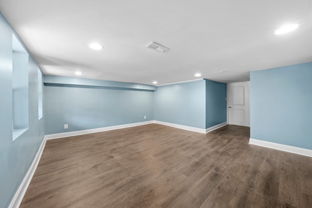 empty room featuring recessed lighting, wood finished floors, visible vents, and baseboards