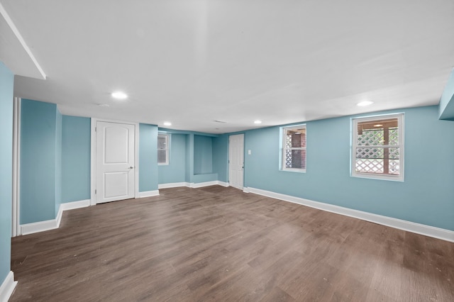 basement featuring recessed lighting, baseboards, and wood finished floors