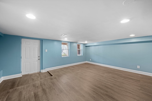 basement with recessed lighting, baseboards, and wood finished floors