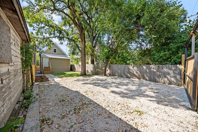 view of yard featuring a fenced backyard and entry steps