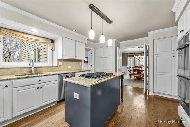 1023 Trillium Trl, West Chicago, IL 60185 - kitchen featuring a sink, appliances with stainless steel finishes, plenty of natural light, white cabinets, and ornamental molding