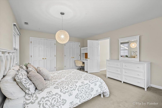 1023 Trillium Trl, West Chicago, IL 60185 - bedroom featuring light carpet, baseboards, and two closets