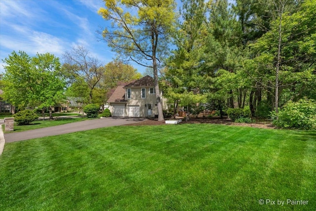 1023 Trillium Trl, West Chicago, IL 60185 - view of front facade with asphalt driveway, a front yard, and a garage