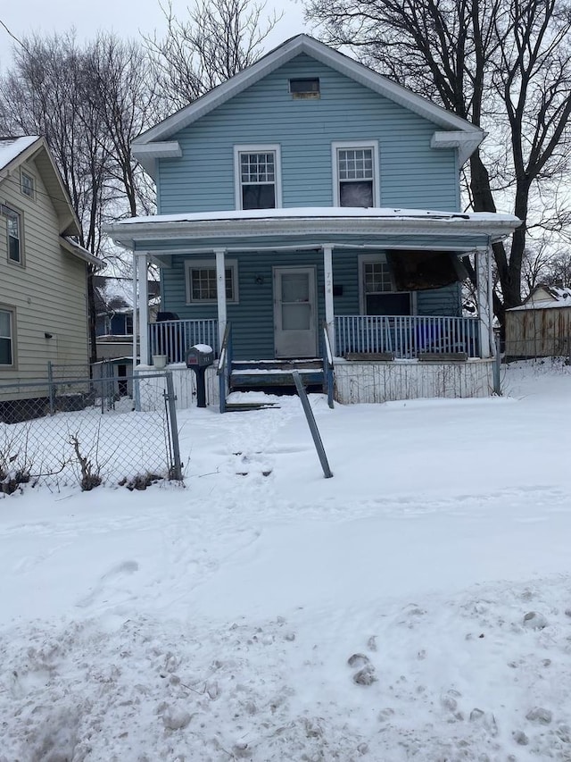 view of front of property with a porch and fence