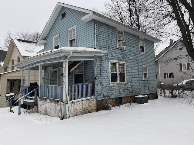 view of front facade featuring covered porch and cooling unit