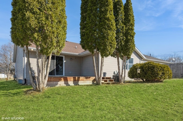 back of house with a lawn