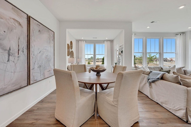 dining room featuring light wood finished floors, visible vents, recessed lighting, and baseboards