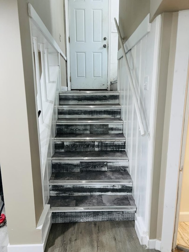 staircase featuring wood finished floors