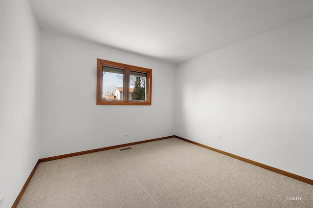 carpeted empty room with visible vents and baseboards